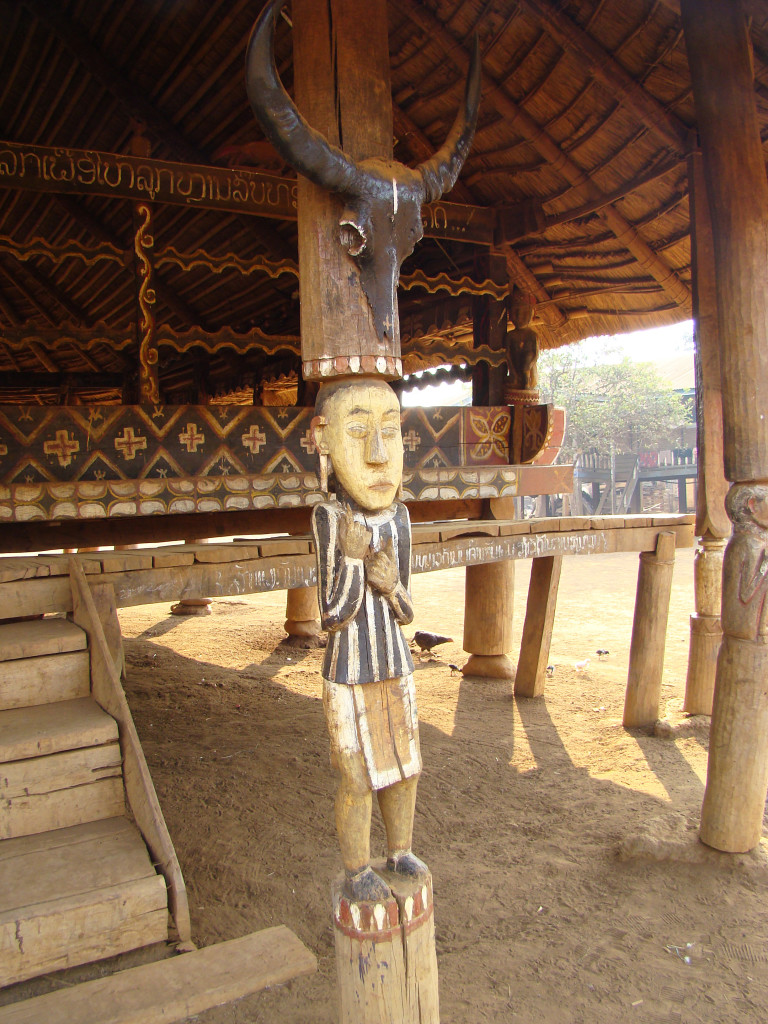 Carvings in front of a Katu community house.