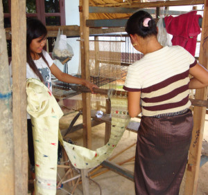 Chola and her daughter taking the butterfly scarves off of the loom for us.
