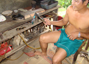 An Akha silversmith showing his workbench and techniques.