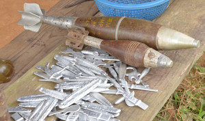 Defused old mortar shells rest next to items  made from their aluminum parts