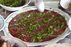The ﬁrst spoon dips into the bowl of fresh duck blood and herbs.