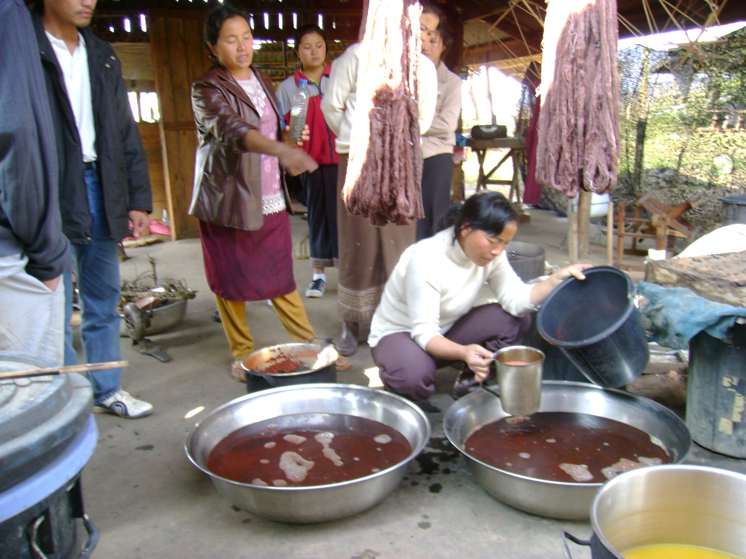 Dyers preparing red silk. Red dye is from the secretion of a scale bug that is called "lac."